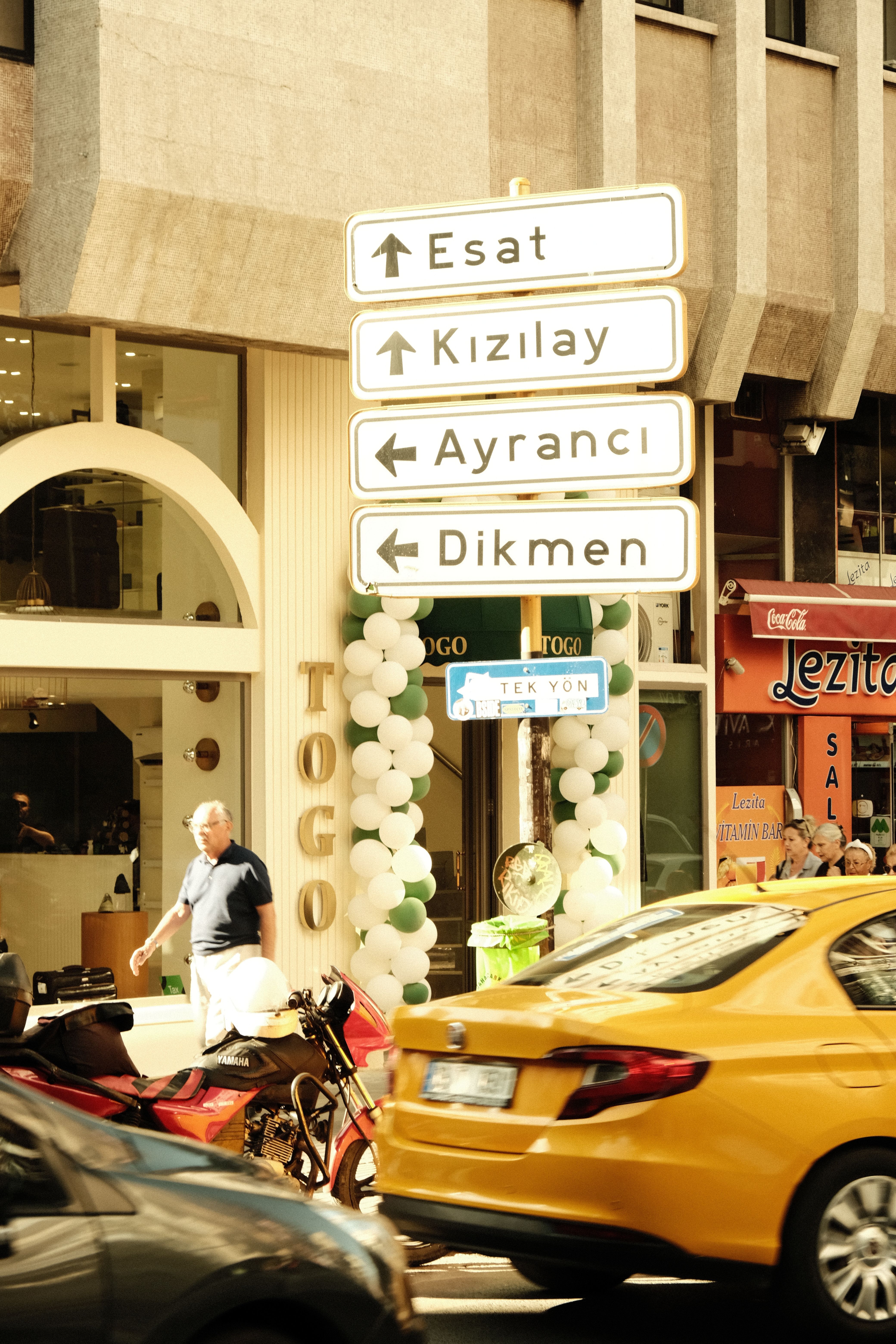City street view in Ankara with traffic signs and pedestrians creating an urban atmosphere.