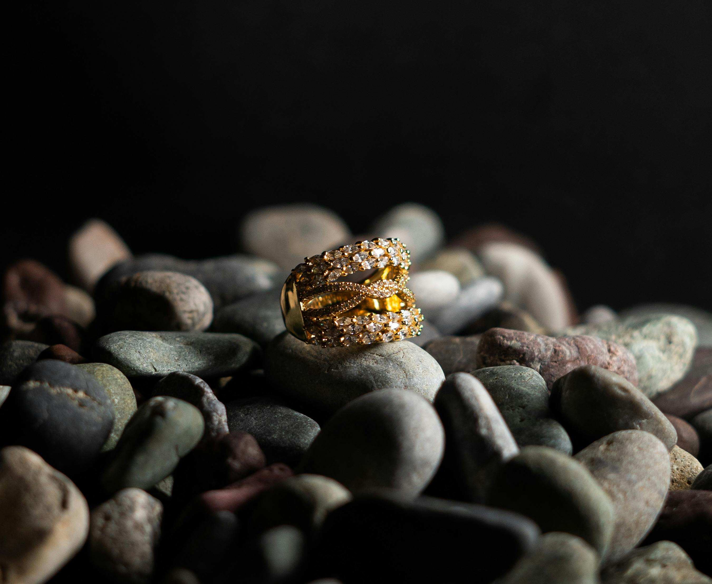 gold ring with diamonds displayed on stones