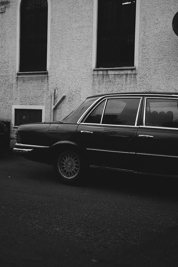 An Old Mercedes Car Parked On The Street In City