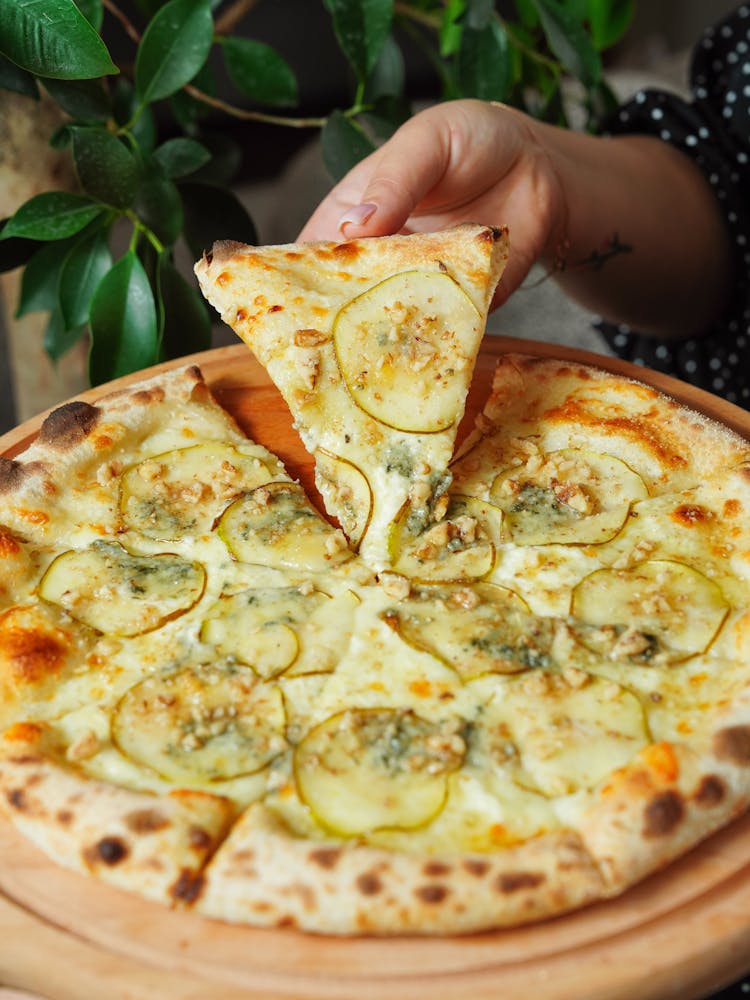 Woman Hand Holding Pizza Slice