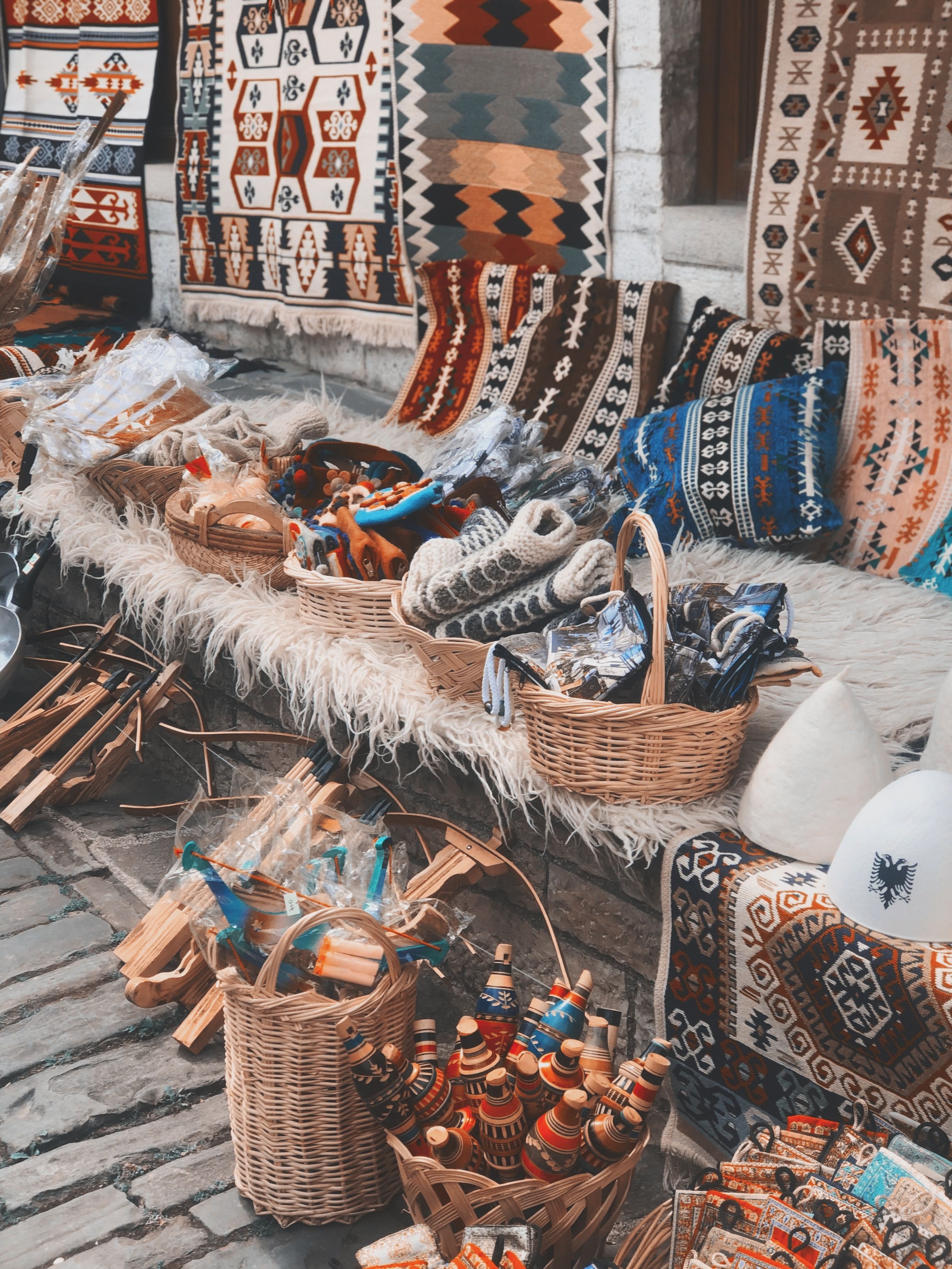 Diverse handmade textiles and crafts on display at an outdoor cultural bazaar.