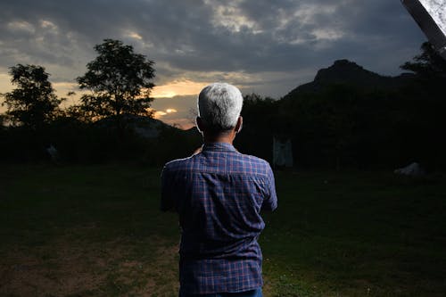 Back View of Man in Shirt at Sunset