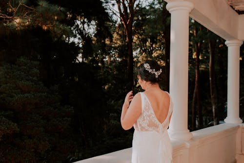 Bride in Wedding Dress Standing on Terrace