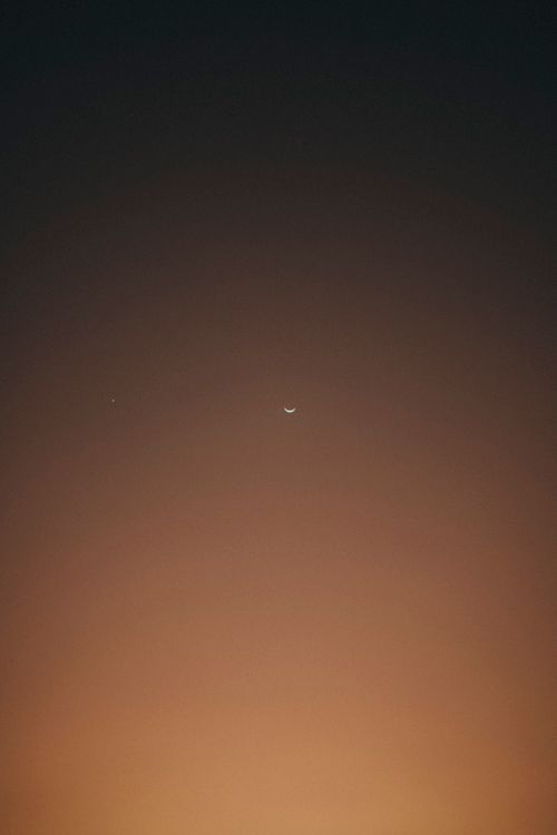 Free A crescent moon in a clear dusk sky with a subtle gradient. Perfect for serene and dreamy visuals. Stock Photo