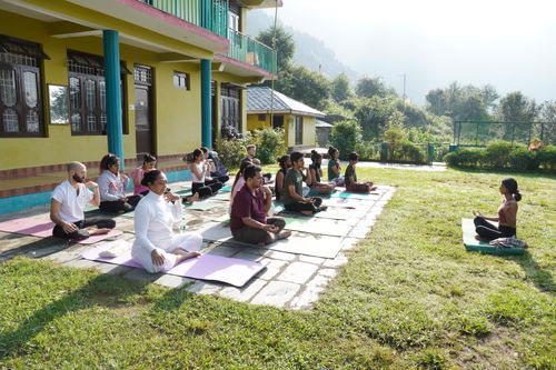 Free A group practicing yoga outdoors in a tranquil garden, promoting mindfulness and relaxation. Stock Photo