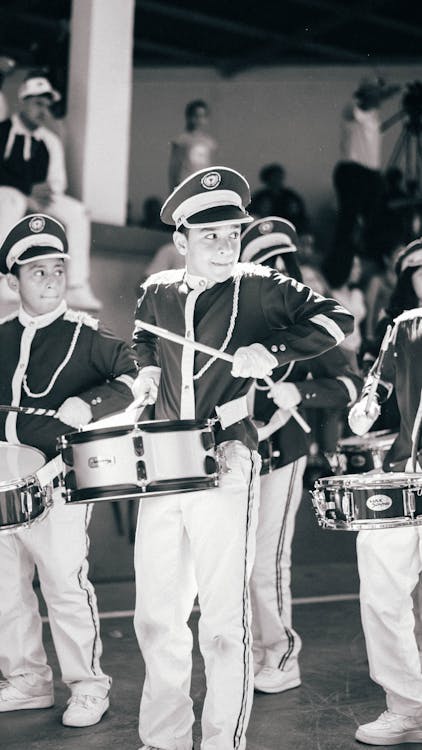 Boys in Uniforms Playing the Drums 