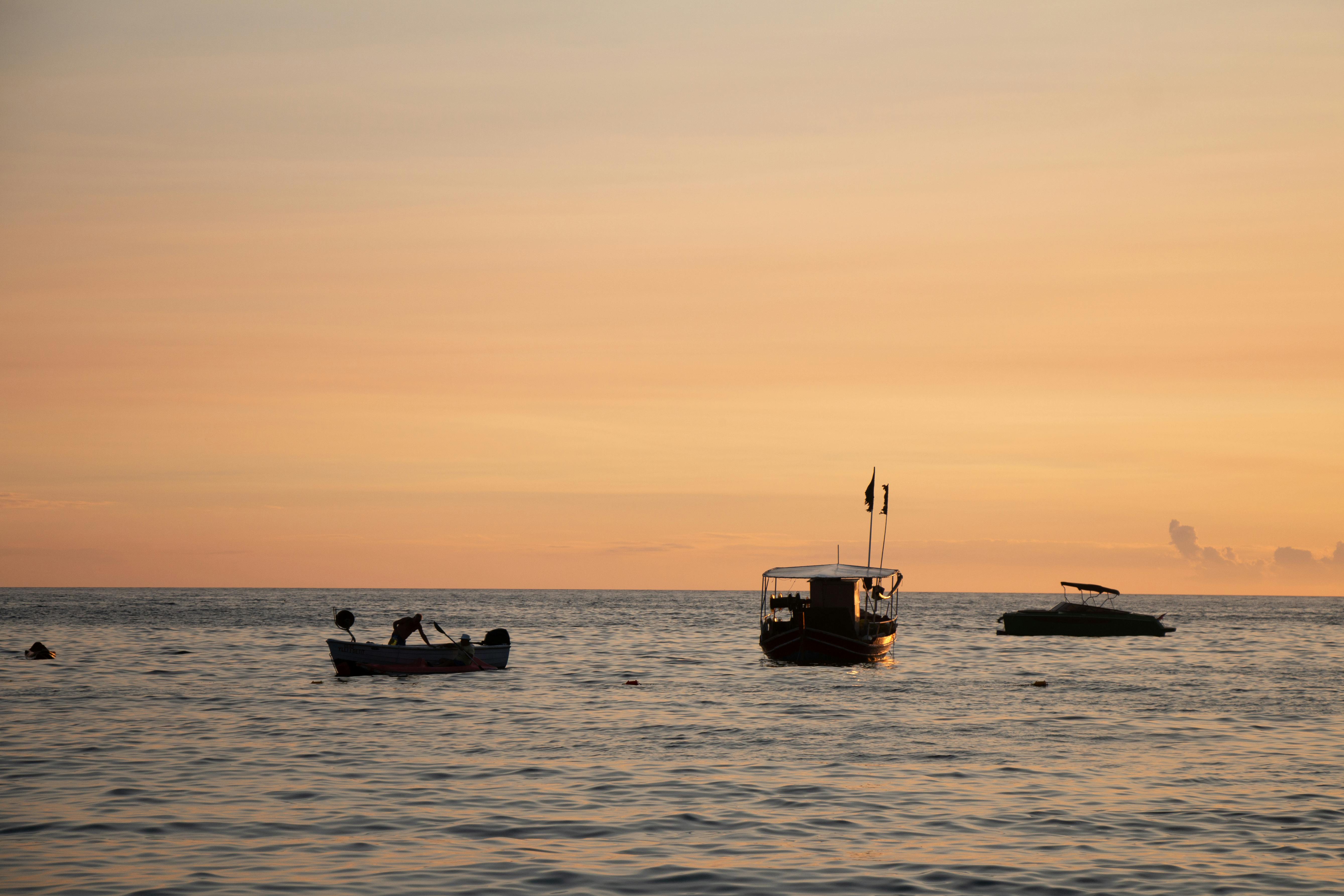 Free Boats Swimming by the Harbor During Sunset  Stock Photo