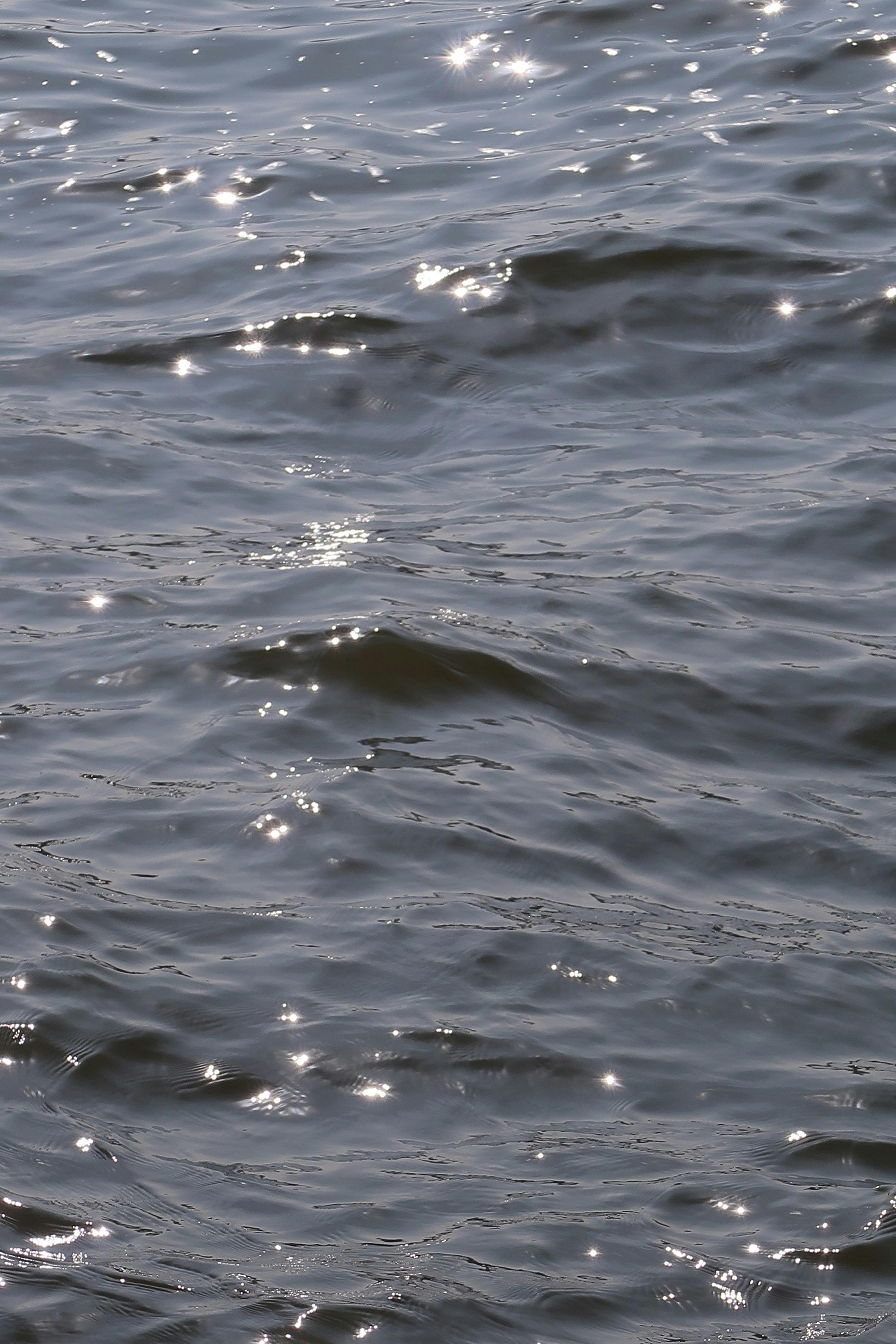 Close-up of sunlight sparkling on gentle ocean waves, capturing serene and calming natural beauty.