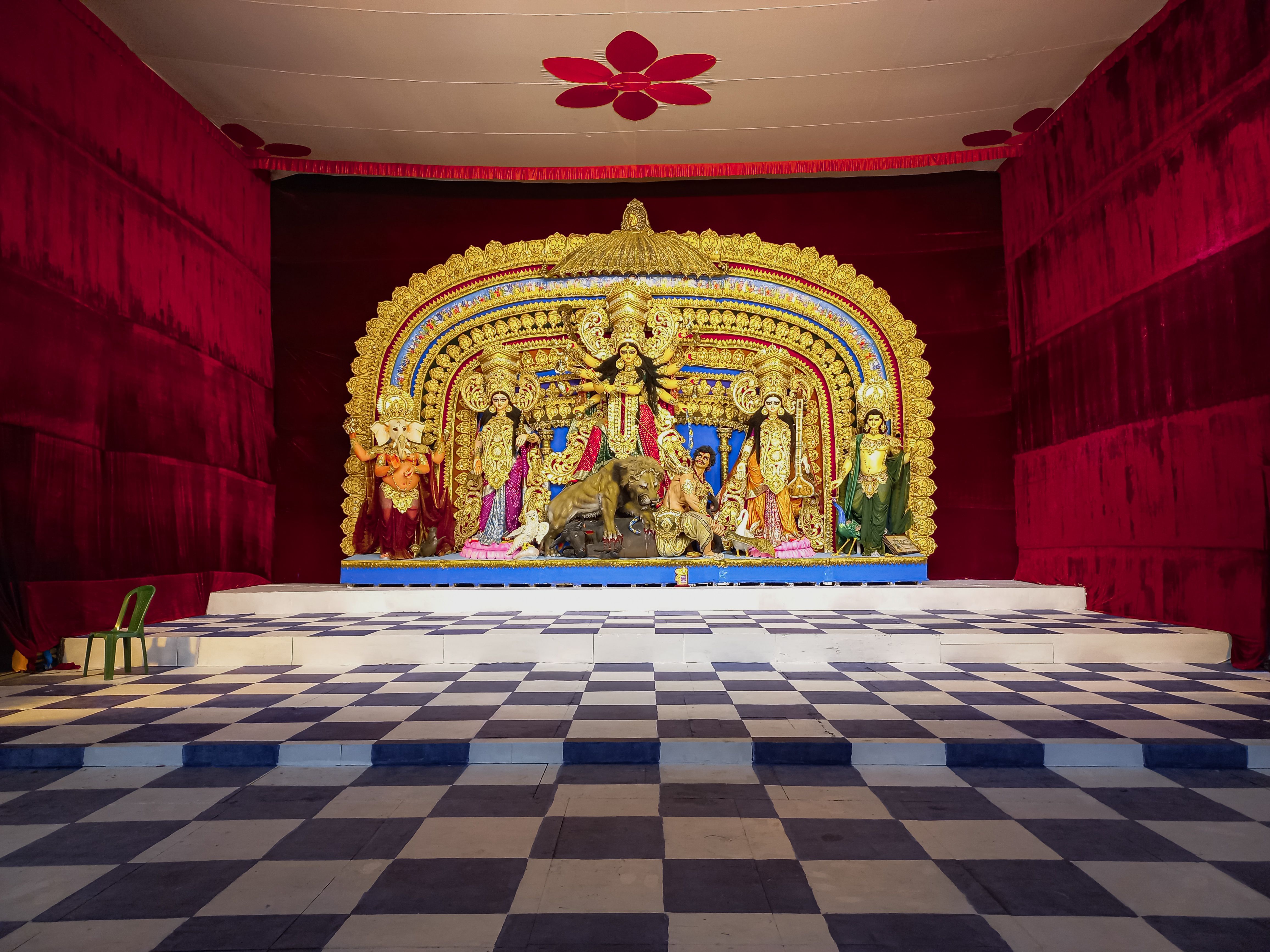 Colorful Durga Puja festival altar with Hindu deities displayed on a stage in Kolkata, India.