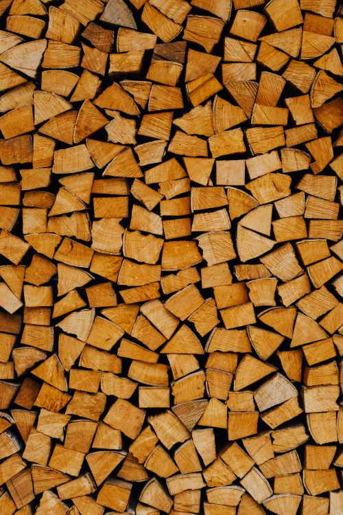 Free A detailed close-up of stacked firewood showcasing natural textures and patterns. Stock Photo