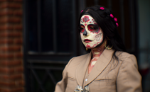 Portrait of a woman in Catrina makeup celebrating Dia de los Muertos in Mexico City.
