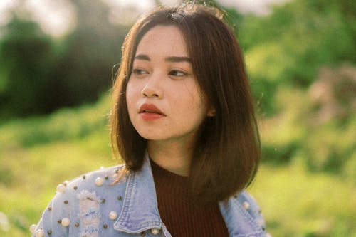 Young Brunette in Jacket with Embellishments in Summer