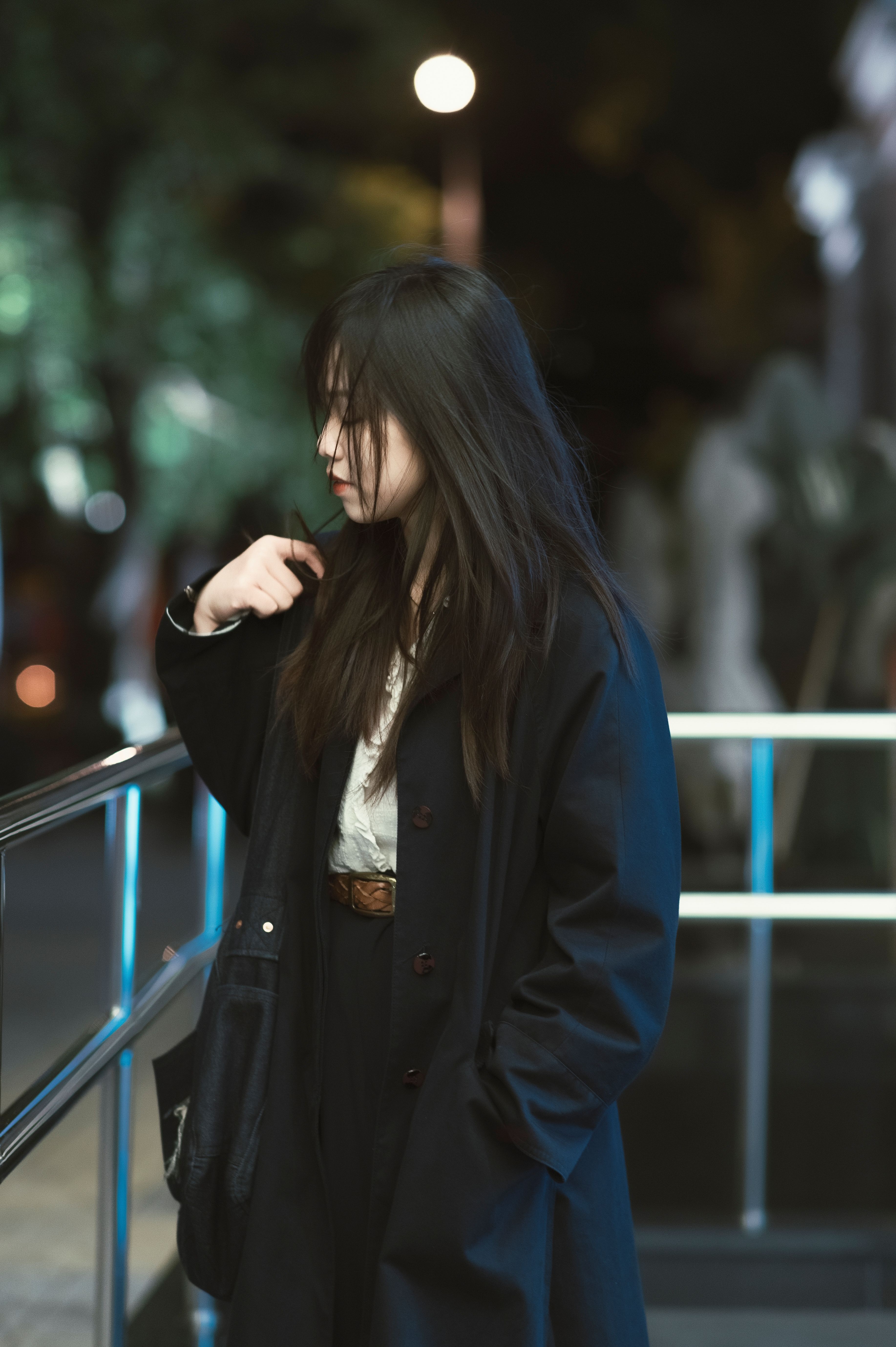Young Woman in a Black Coat Standing in City at Night · Free Stock Photo