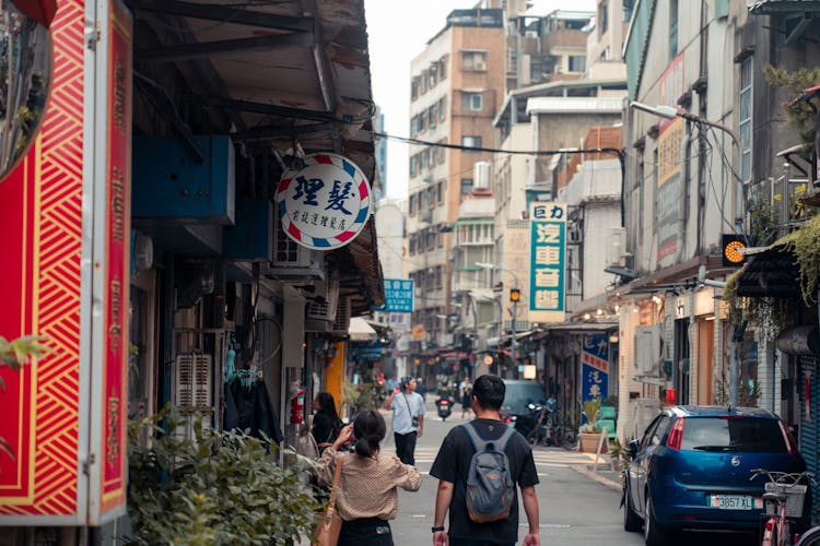 People Walking Down The Street In A Chinese City