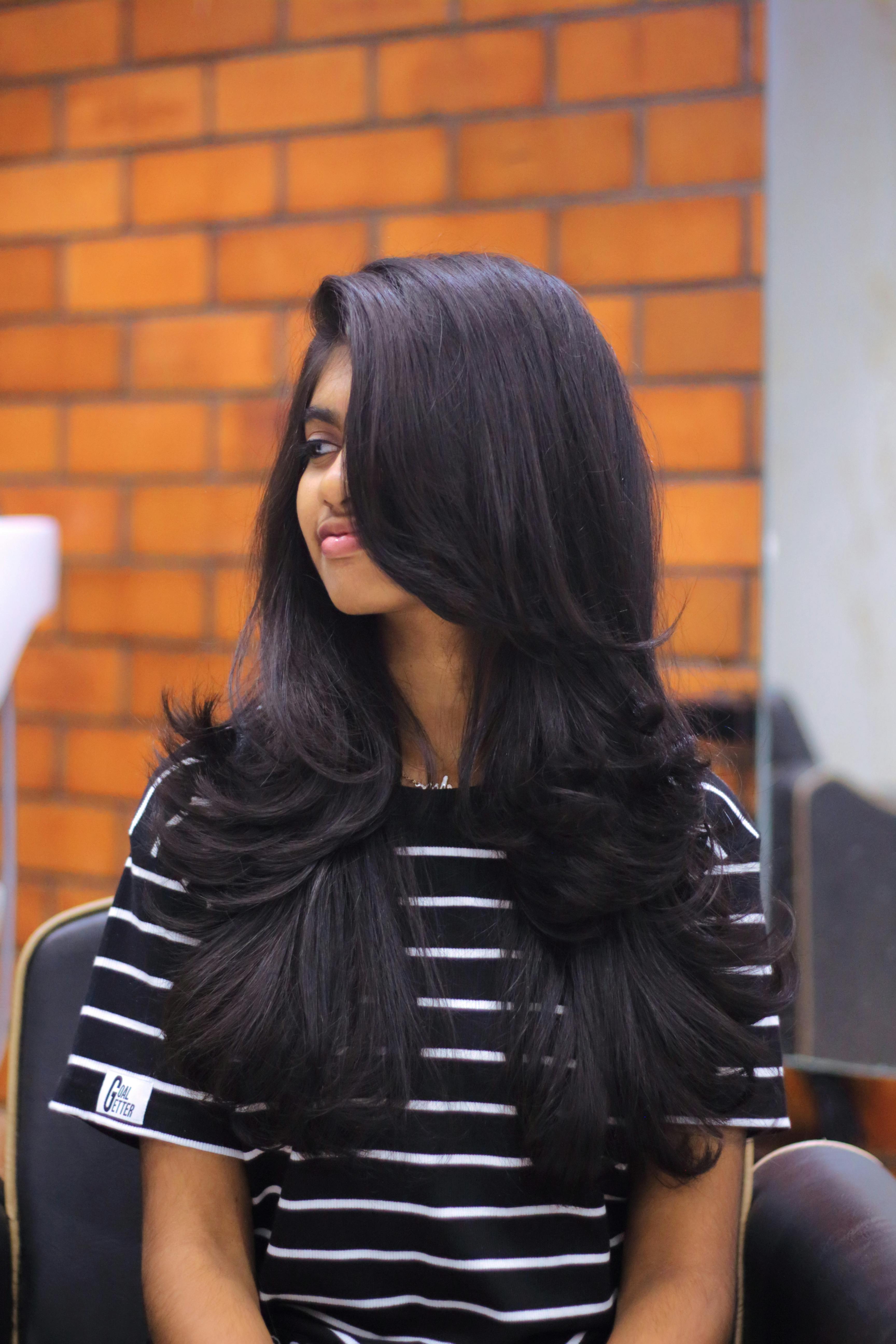 Young Woman with a Layered Haircut Sitting in a Hair Salon · Free