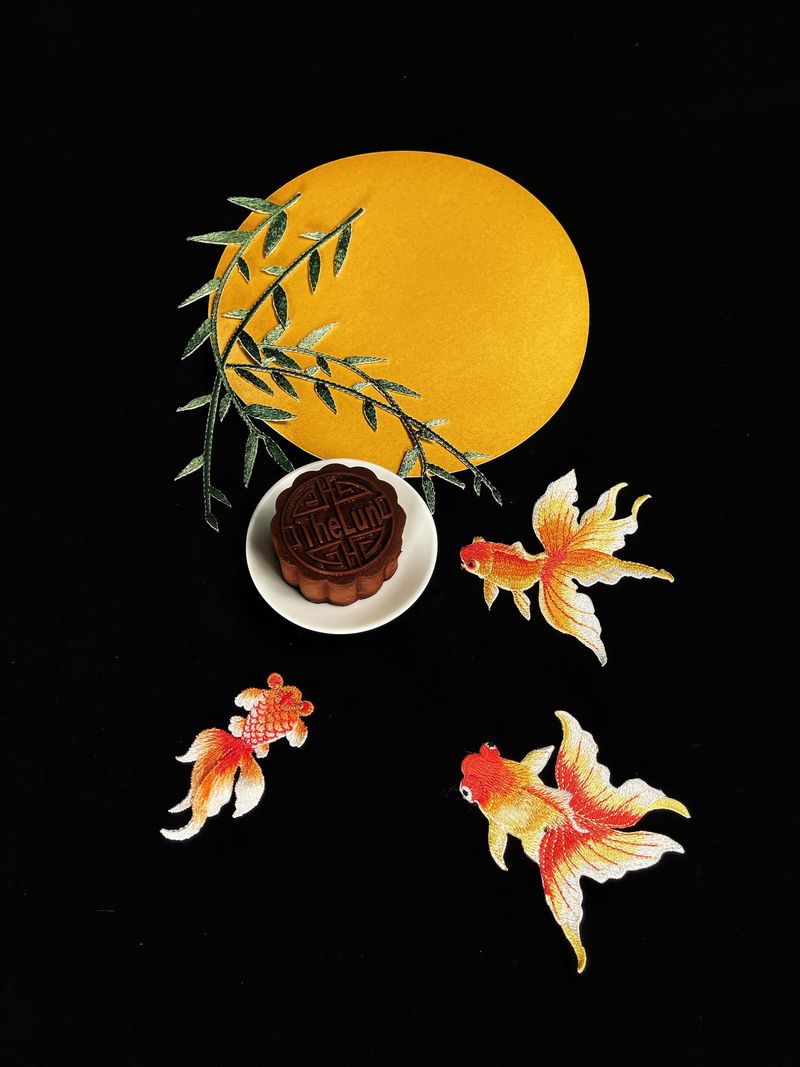 A single mooncake on a plate, showcasing its golden crust and intricate pattern