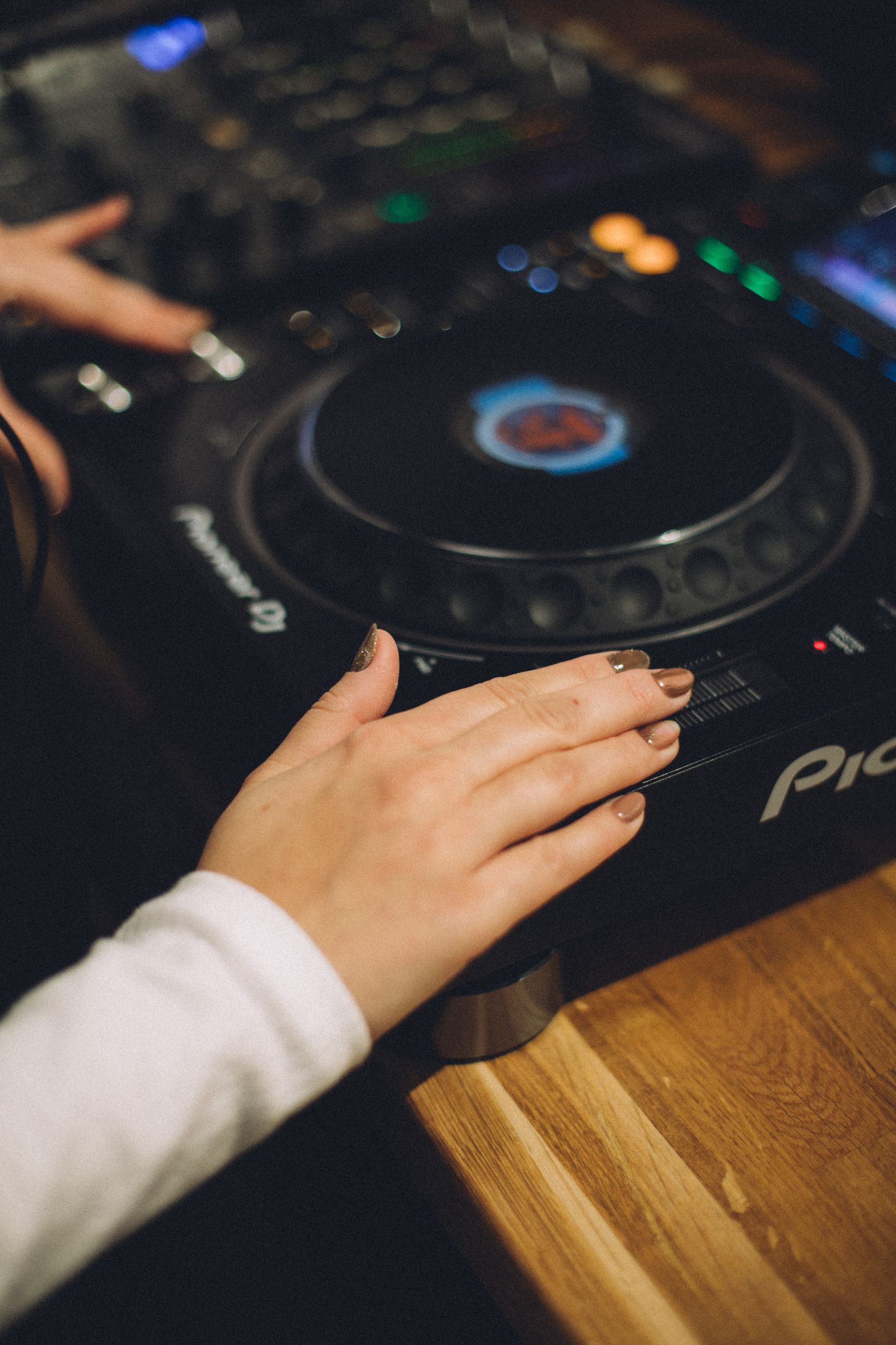 Hands mixing music on a DJ desk