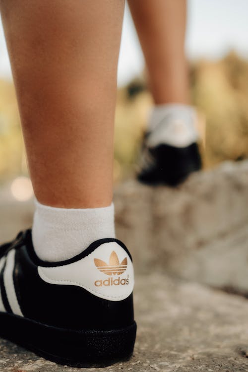 A Person Wearing Adidas Superstar Sneakers
