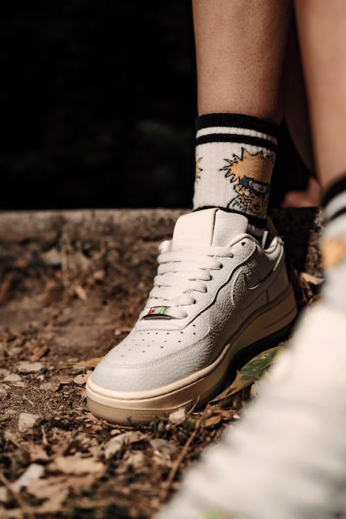 A Person Wearing Nike Air Force 1 Sneakers