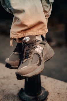 Close-up of trendy sneakers worn with casual pants, capturing urban street fashion.