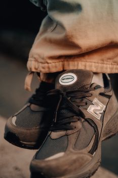 Detailed close-up of trendy black sneakers on a casual outing, showcasing footwear style.