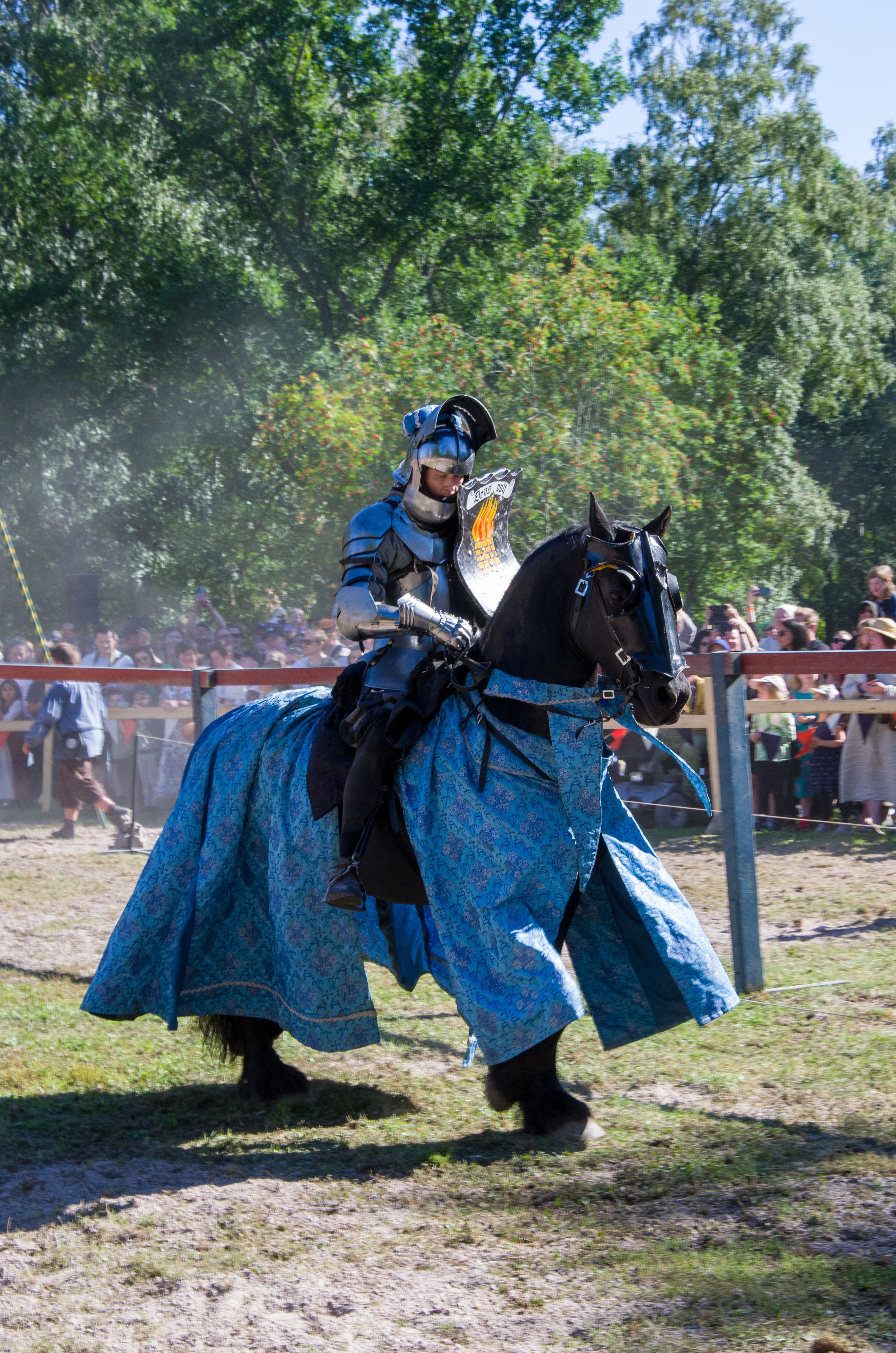 A Man Wearing an Armor Riding on a Horse at a Festival · Free Stock Photo