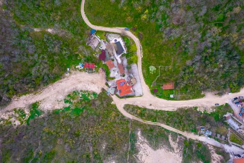 Free Aerial image showcasing a rural landscape with dirt roads and scattered houses. Stock Photo