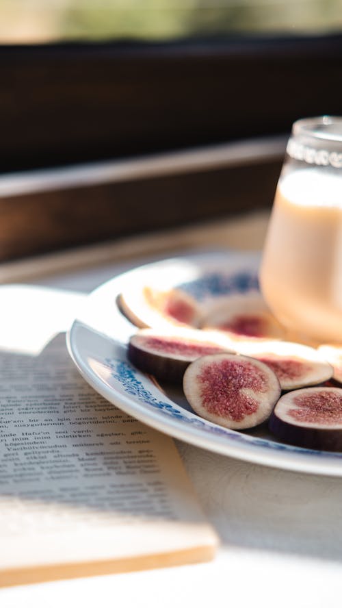 Fig on a Plate Next to a Book