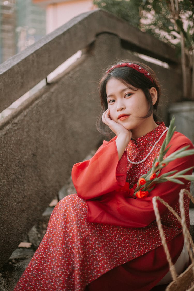 Girl In A Red Dress Sitting On The Red Dress