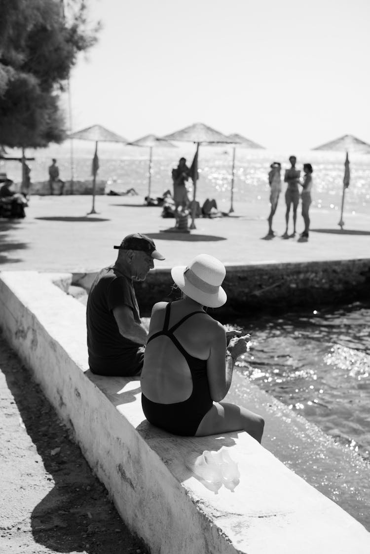 People Sitting By A Sea