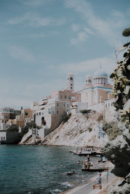 Explore the stunning architecture and blue waters of Ermoupoli in Syros, Greece.