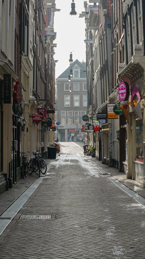 A Narrow Alley between Historic Buildings in Amsterdam, the Netherlands 