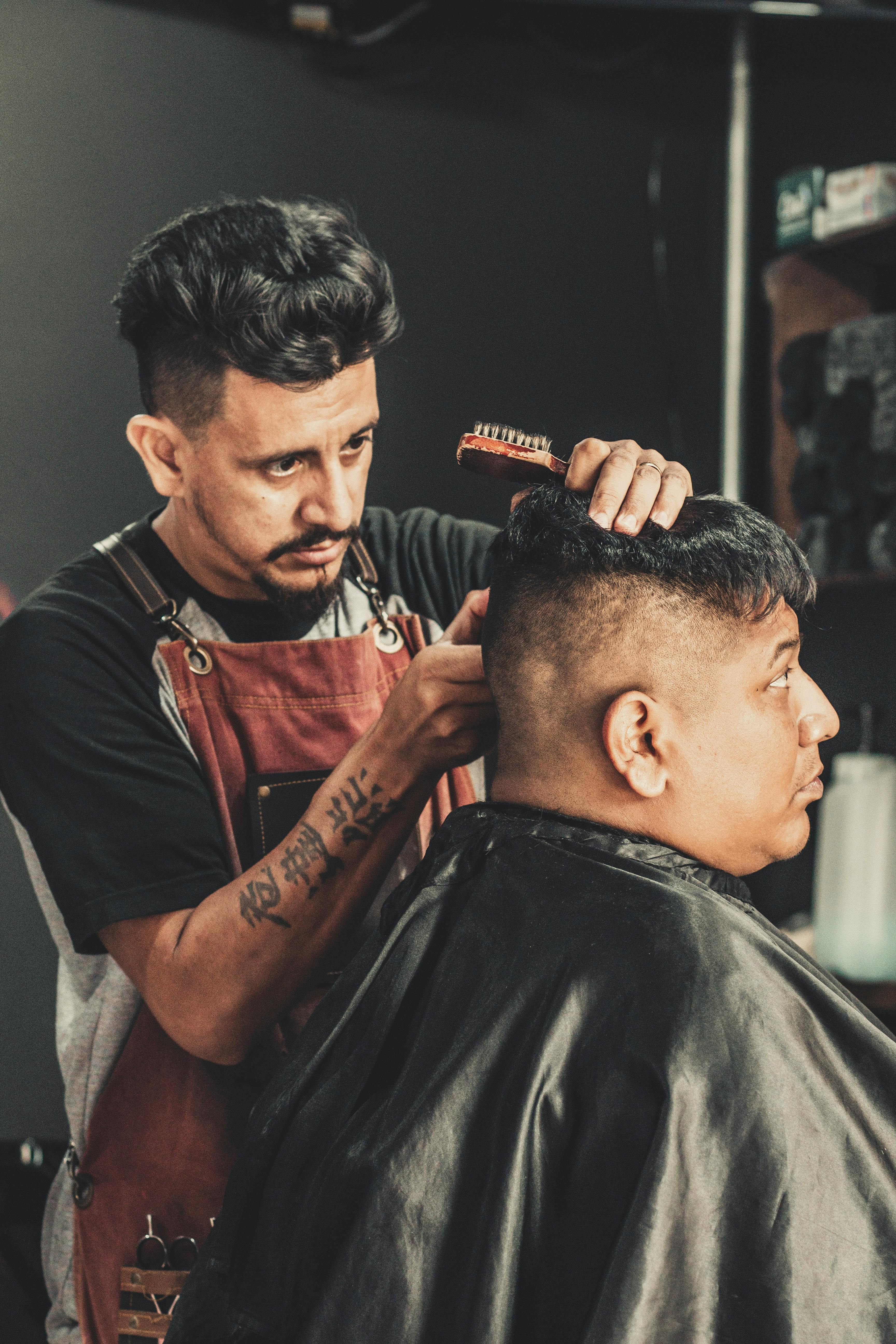 Barber Cutting Mans Hair  Free Stock Photo