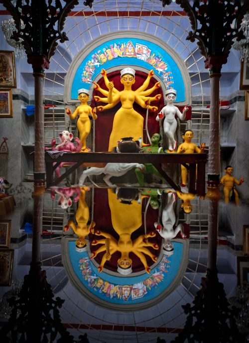 Free Colorful Hindu goddess statues reflected in temple setting, Kolkata, India. Stock Photo