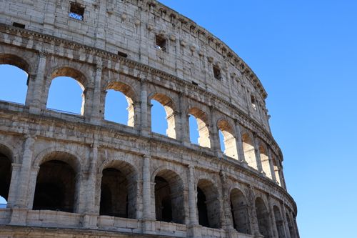 Free Close-up of the iconic Colosseum in Rome under a vibrant blue sky. Stock Photo