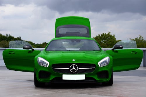 A Green Mercedes-AMG GT with Open Doors and Trunk