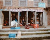 Little Boy Standing in front of a Shop in an Old Building