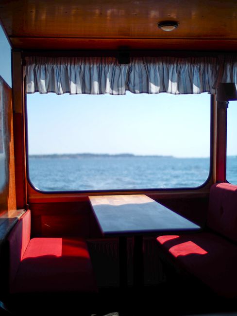 Serene ferry interior with a window view of the ocean in Helsinki, ideal for travel enthusiasts.