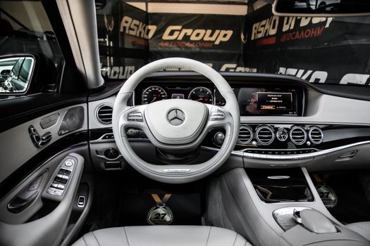 Modern Mercedes-Benz car interior with detailed dashboard and steering wheel view.