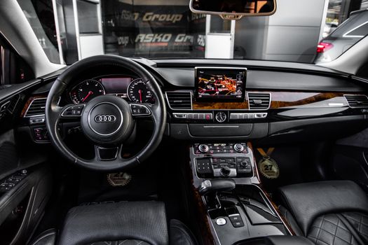 High-end car interior showcasing black leather seats and modern dashboard with navigation display.