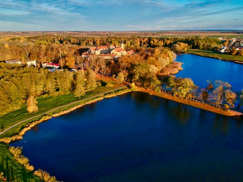 Free Stunning aerial view of an autumn landscape with a lake and trees in Niasviž, Belarus. Stock Photo