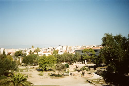 Ruins in Park with Athens Buildings behind