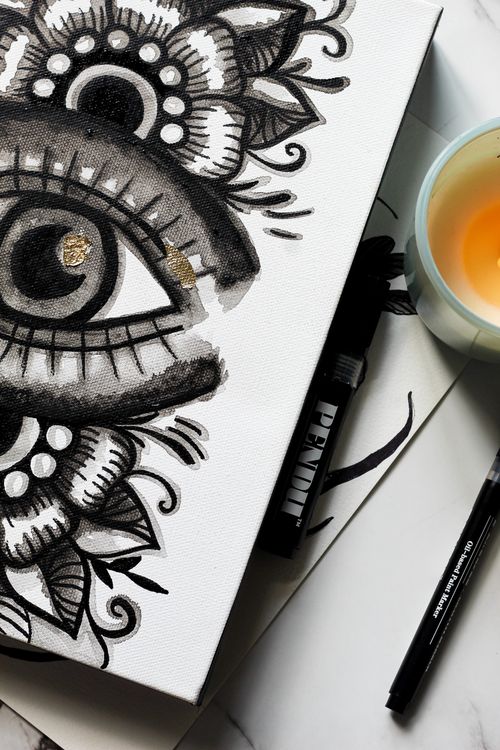 Free Close-up of a detailed eye illustration on paper, surrounded by markers and a candle. Stock Photo