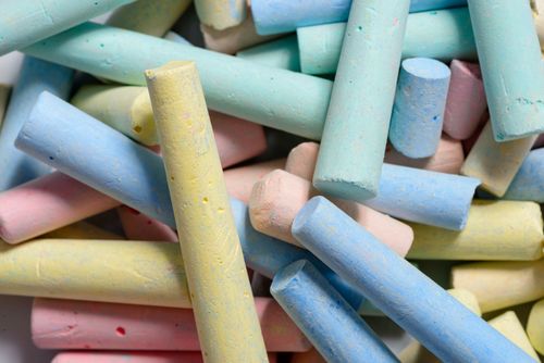 Free A vibrant close-up of colorful chalk sticks stacked and scattered, perfect for educational themes. Stock Photo