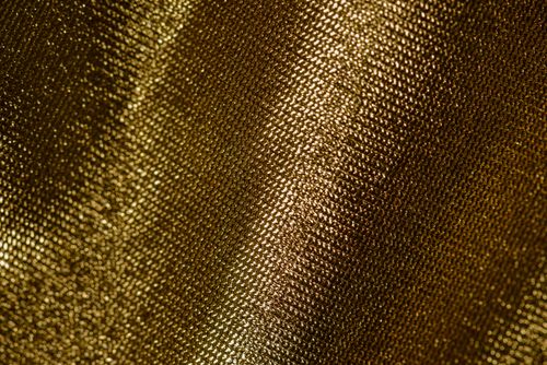 Free Close-up of shimmering gold textile showcasing intricate texture and shine. Stock Photo