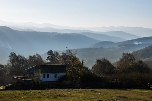 A House on a Field in Mountains