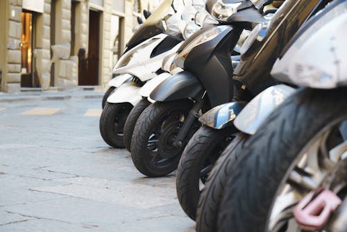 Close-up of Motor Scooters Parked on a Street 