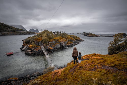 Mother and Child Standing on Hill Overlooking Bridge to Island 