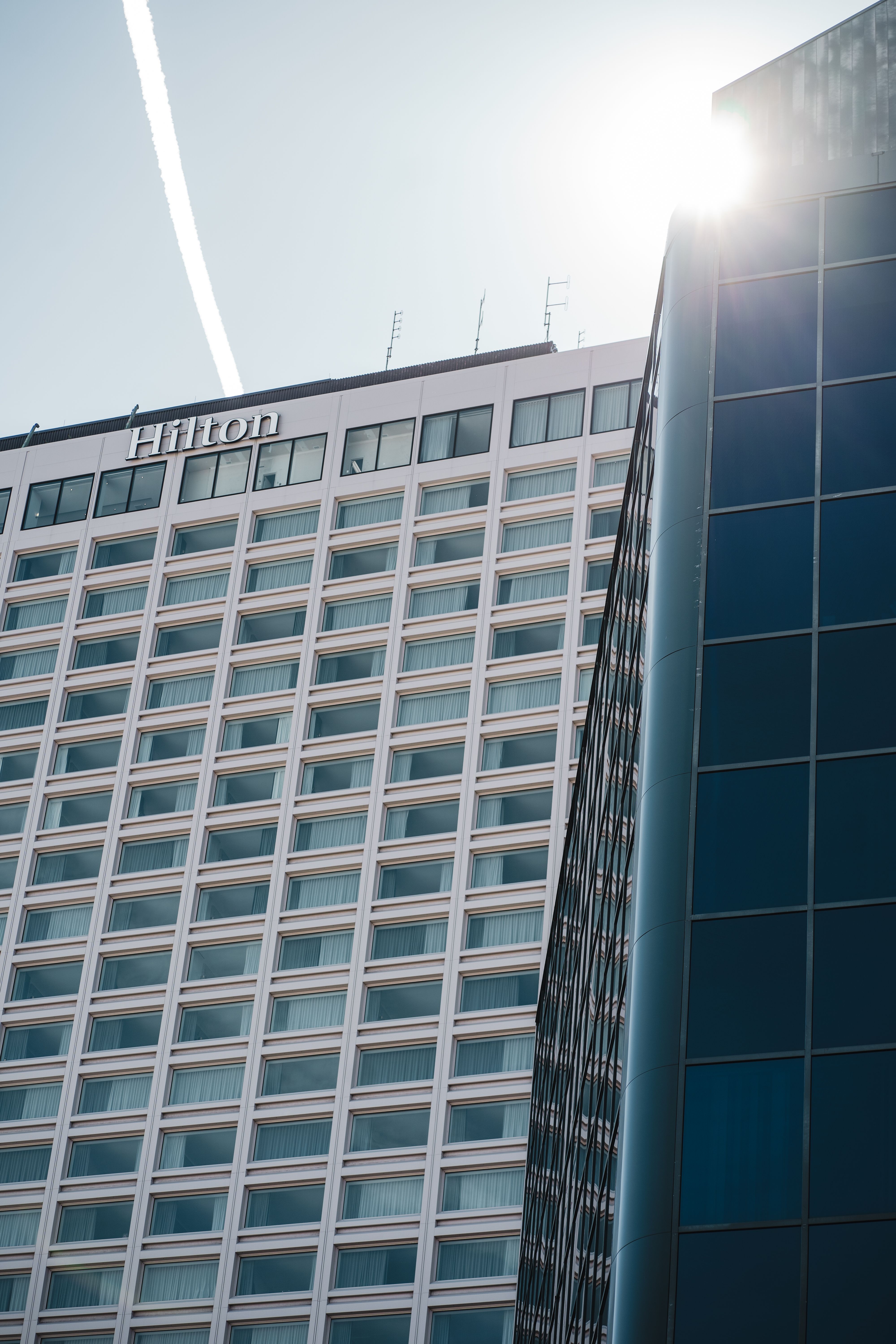Modern skyscrapers including Hilton Hotel in Québec City under bright sunlight.
