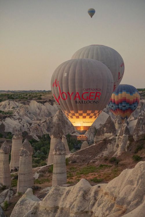 Free Hot air balloons soaring over the rock formations of Cappadocia, creating a magical and dreamy atmosphere. Stock Photo